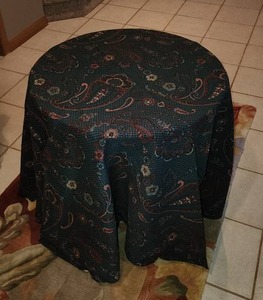 lot 11 image: Round Unfinished Side Table with Blue Table Cloth with Maroon Paisley print - Measures 23.5 diameter and 24 high