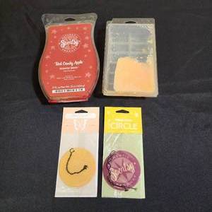 lot 324 image: Open Package Scentsy Red Candy Apple Wax Bar (Large package - half full), Another partially full unbranded wax package, and two Scentsy Car Air Fresheners