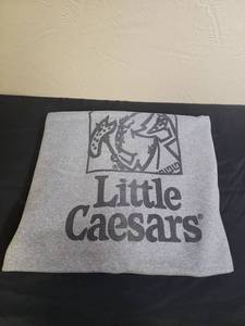 lot 372 image: Little Ceasars Pizza Gray Sweatshirt Sports Blanket 64 x 53 - heavy sherpa lined blanket.  Has heavy piling. Would make a good stadium blanket, blanket for a dog or making horse blankets. Has one small cut on the edge