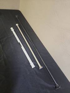 lot 392 image: Tension Rods and a Curtain Rod - including a brand new Mainstays Easy Hang Shower Rod 27-40 inch, a used chrome rod and a black curtain rod 47-78 with square finials (finials have some paint wear on them)