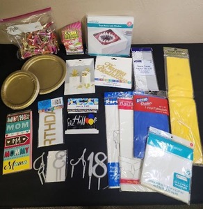 lot 429 image: Party Supply Bundle - gold plates, gift and treat boxes, tissue paper, plastic table cloths, cake toppers, banners, Birthday Queen sash, streamer, a card for Mom, and a bag of drink umbrellas.  Most are new in package.