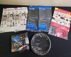 lot 430 image: Graduation Party Supply Bundle - photo booth props, 2 black plastic table cloths, swirl hanging decor, black paper plates, and Grad napkins (napkins are open bag but look new, all others new in package)