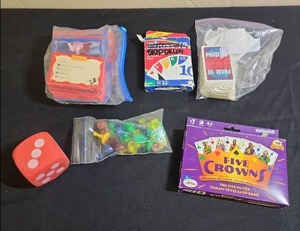 lot 446 image: Family Card Game Bundle with Five Crowns, Phase 10, Disney Trivia - includes a bag of extra board game pieces and a large foam dice