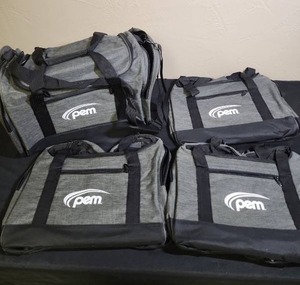 lot 484 image: 4 brand new gray duffle bags with PEM company logo