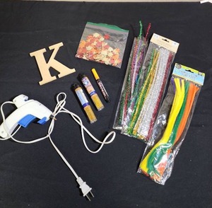 lot 421 image: Craft Supply Bundle with Hot Glue Gun - includes a wooden letter K, gold glitter, bag of autumn leaves, pipe cleaners, and a chalk marker