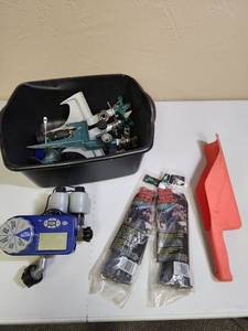 lot 524 image: Orbit Automatic Water Timer Model 27152, a tub with several sprinklers, a gutter scoop, and two new bags of spikes for garden edging