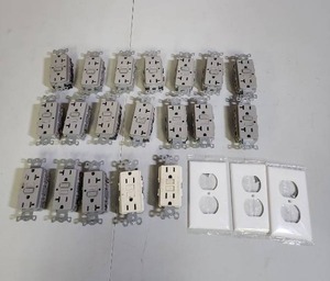 lot 568 image: Bulk GFCI Electrical Outlets and Cover Plates - gray ones appear to be in new condition, and 3 in package outlet covers
