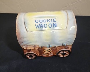 lot 676 image: Western Covered Wagon Cookie Jar - has a crack through the lid