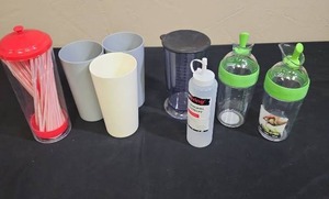 lot 677 image: 3 plastic drinking cups, straw holder, salad dressing dispensers, measuring cup and condiment bottle