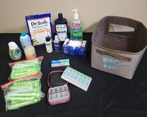 lot 717 image: Mixed Health and Personal Care Items Lot includes a fabric tub for storage, epsom salt, bubble bath, pill organizers, tampons and more