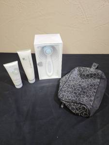 lot 720 image: Nu Skin AgeLOC LumiSpa Skincare Device new in box (Retails for $225) with almost full bottle of the treatment cleanser, and a partially used bottle of NuSkin Ageloc Dermatic Effects (for body - to reduce cellulite)