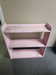 lot 311 image: Pink Wooden Bookshelf Unit with open back - measures 27.25 W x 8 D x 28.5 H - very dirty, has edge wear on the front of top shelf