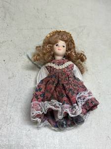 lot 545 image: Small Porcelain Doll with Floral Dress and Straw Hat