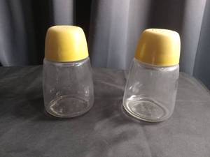 lot 2334 image: Glass Salt Shakers with Yellow Lids