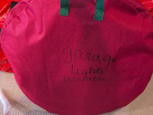lot 2672 image: Holiday Lights Wreath Storage Bag full of lighted wreaths