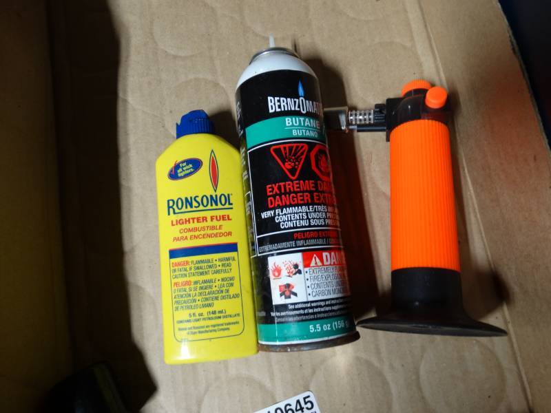 lot 10645 image: Small Torch with Butane and lighter fluid