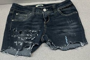 lot 5688 image: Paris Blues denim shorts feature a medium-dark wash with heavy factory-made fraying and rips across the front panel (Size 11)