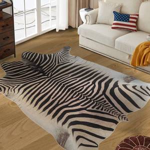 lot 5637 image: Guyekobe Large Zebra Rug 7.6x6.2 ft Beige and Brown Area Rugs Faux Cowhide Rugs for Bedroom Living Room Dining Room Low Pile Animal Rug Non-Slip-No Fur has some soap spill alongside the right corner of the bag
