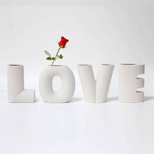 lot 11674 image: 4-Piece White Ceramic Modern Minimalist Design Decorative Love Letter Vases Set, Wedding Party Home Decor (Small Damage)