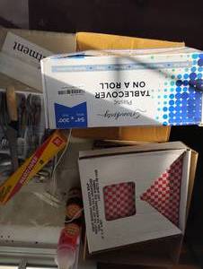 lot 18493 image: Contents of Table Including Tablecloth on Roll, Green Thank you Bags, Red Checker Liners, Silverware and MORE