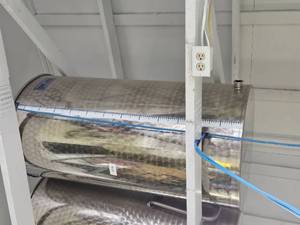 lot 18584 image: Damaged 100 Gallon Stainless Steel Tank W Stand and Valve