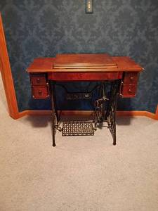 lot 200 image: Singer Treadle Sewing Machine with Cabinet. With 4 Drawers, PLUS Contents.  Open, 30 x 47 x 17.  Closed  30 x 35 x 17.  Located Upstairs