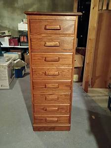 lot 304 image: Oak Filing Cabinet.  4 Drawers.   53 x 21 x 25.   Located in Basement