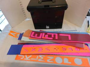 lot 1218 image: Laminated stencils and strips, plus a file case