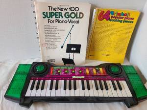 lot 1296 image: Kawasaki Electronic Keyboard with Piano Books