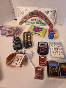 lot 1353 image: Australian boomerang, cards, handheld electronic toys.