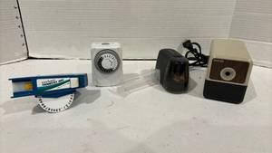 lot 1803 image: Two pencil sharpeners.  One electric and one battery, a light timer, business card holder and a label maker