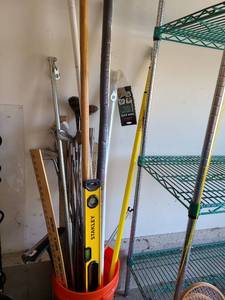 lot 3622 image: Stanley level, assorted poles, golf clubs.