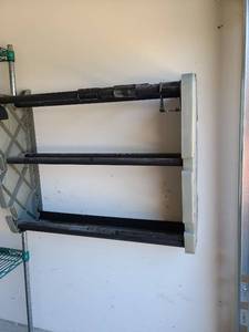 lot 3627 image: Sports balls storage rack, 34in wide, BRING A FLAT HEAD SCREWDRIVER to remove from garage wall.