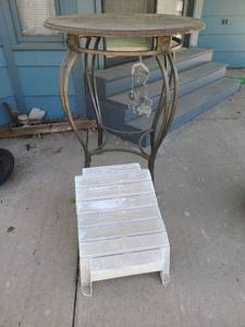 lot 5005 image: Outdoor pub table, 42x34, footstool. Top of table in rough condition.