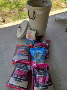 lot 5006 image: Trash can with contents of charcoal, bags of Traeger hardwood pellets and Hickory chunks.