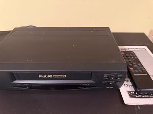 lot 66 image: Philips Magnavox VCR w Remote and Instruction Manual