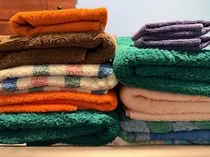 lot 105 image: Towels in a White Hamper