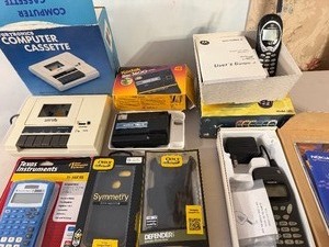 lot 501 image: Vintage to Newer Small Electronics - Computer Cassette, TI Calculator, Otter Phone Cases and More