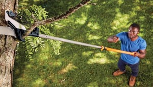 lot 150 image: Fiskars Power-Lever 14 ft. Steel Curved Extendable Tree Pruner Retails $70