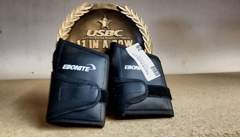 lot 28 image: 2 Bowling Wrist Guards and 11 Strike In A Row Trophy