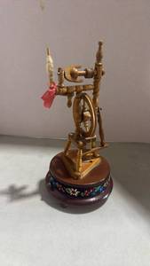 lot 1006 image: Reuge Handmade Music Box fashioned as a Swiss-style spinning wheel 9 inches tall