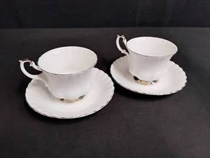 lot 1105 image: Two Royal Albert White and Silver Teacup Set - One has some cracks.