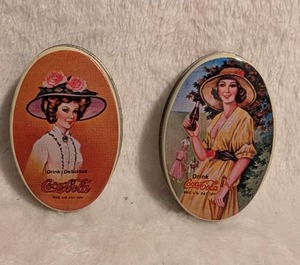 lot 5014 image: Coca-Cola Mini Oval Metal Advertising Tins - 2 ct
