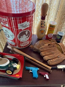 lot 46 image: Tin of Balls, Toy Guns, Glove, Car Planter and More