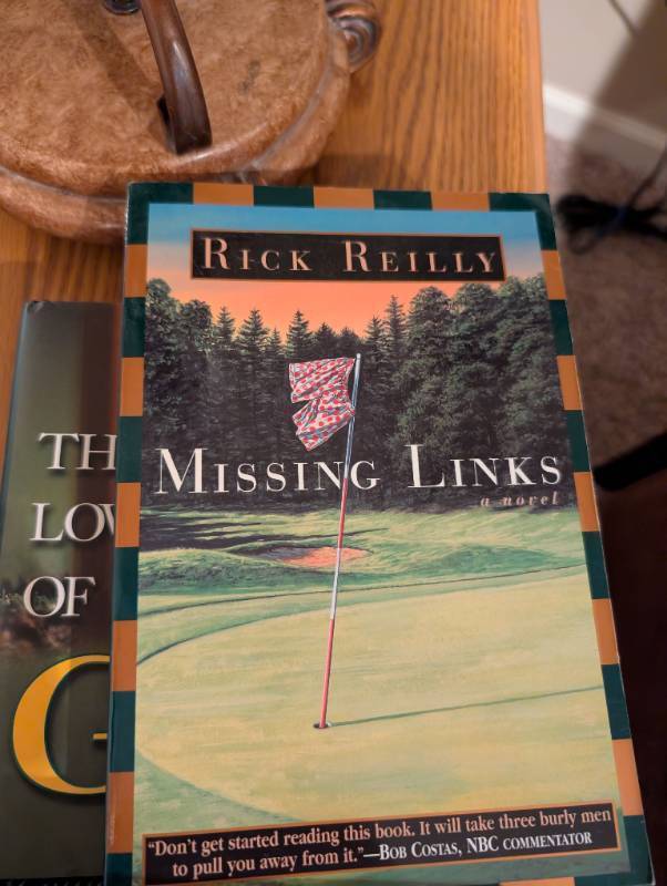 lot 2567 image: The Missing Links by Rick Reilly - Golf Novel- gold book lot