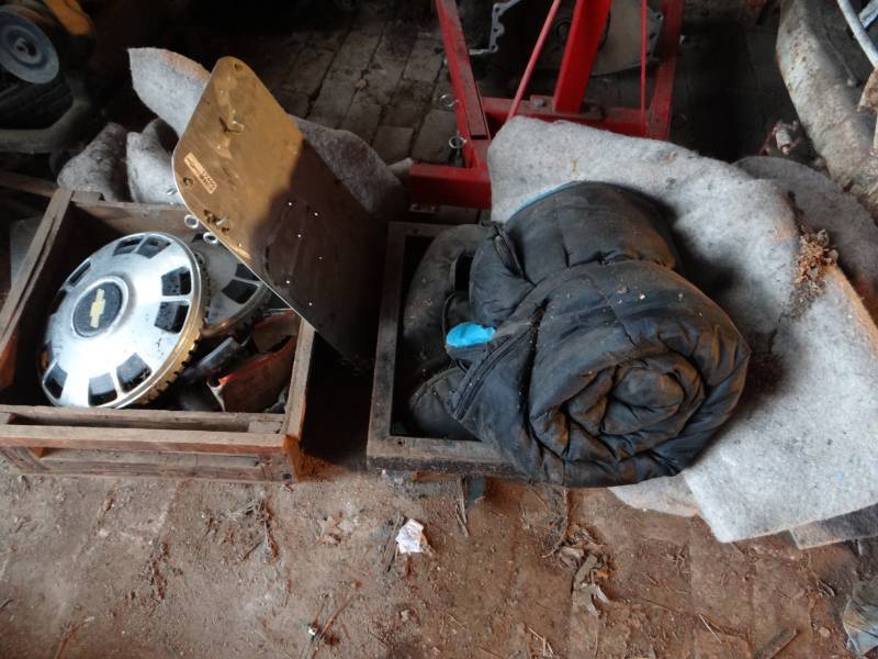 lot 17499 image: Lot of car parts, sleeping bag, crates, blankets, & more.