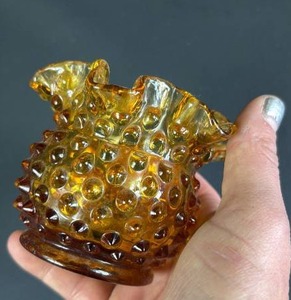 lot 15 image: Vintage Fenton Amber Glass Hobnail Ruffled Edge Posey Vase