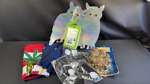 lot 386 image: Bundle includes a (4) hanging rainbow holographic owl-shaped scarecrows with yellow eyes, cannabis leaf flag design item, KenWorth Lug Nut Covers, Thinsulate Gloves and Face Masks with Filters