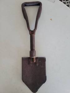 lot 21103 image: steel folding shovel with serrated edge and collapsible handle.