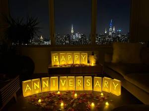 lot 62383 image: Happy Anniversary Decorations Light up Letters with 30 Tea Lights Candles and 2000 Rose Petals Included - Luminary Paper Bags to be Used as Happy Anniversary Banner and Anniversary Decorations - Retail $38